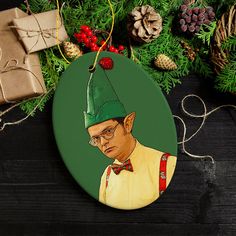 a christmas ornament with an image of a man wearing a green hat