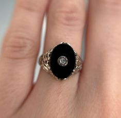 Oval onyx ring with a decorative diamond centre and beautiful detailed white gold frame shoulders and band.  Preloved item Size (approx.): 4.5 US Stamped 14K Weight: 2.137g **FREE shipping within Canada and USA** If you have any questions or concerns, please do not hesitate to contact us. We will be more than happy to help you and answer any inquiries.  We invite you to check out our shop for more fabulous items! Oval Black Enamel Diamond Jewelry, Oval Diamond Jewelry With Black Enamel, Elegant Oval Black Enamel Ring, Formal Oval Enamel Ring With Black Enamel, Formal Oval Black Enamel Ring, Formal Black Enamel Oval Ring, Black Oval Enamel Ring For Formal Occasions, Oval Enamel Diamond Ring For Anniversary, Oval Diamond Enamel Ring For Anniversary