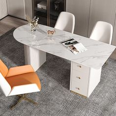 a white marble dining table with orange chairs