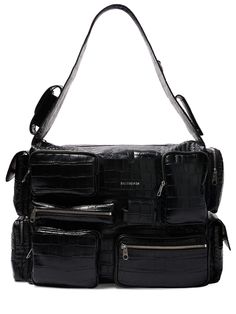 Find BALENCIAGA Superbusy Leather Sling Bag on Editorialist. Height: 29cm Width: 42cm Depth: 19cm. Fixed strap. Top zip closure. Front logo details. All over embossed pattern placement may vary. Multiple front and side 3D pockets. One back zip pocket Designer Shoulder Bag Backpack Style, Designer Hobo Bag With Top Carry Handle For Travel, Luxury Hobo Shoulder Bag With Gunmetal Hardware, Luxury Crossbody Hobo Bag With Gunmetal Hardware, Luxury Hobo Bag With Gunmetal Hardware Crossbody, Designer Travel Hobo Bag With Zipper, Luxury Black Hobo Bag For Travel, Designer Travel Shoulder Bag With Gunmetal Hardware, Designer Black Hobo Bag For Travel