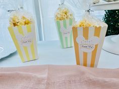 two bags of popcorn sitting on top of a table