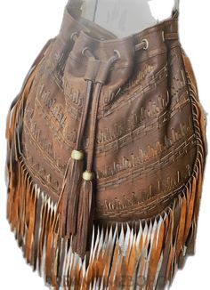 Bohemian Bucket Bag, Bohemian Brown Bucket Bag, Bohemian Pouch Shoulder Bag With Tassels, Leather Fringe Pouch Bag, Bohemian Hobo Bag With Tassels, Bohemian Leather Hobo Bag With Tassels, Leather Hobo Bag With Tassels, Traditional Fringe Bag, Leather Hobo Bag With Tassels In Tote Shape