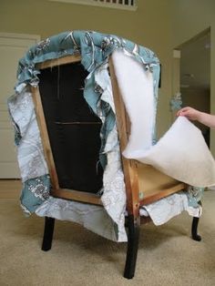 a chair that is sitting on the floor with a sheet covering it's back