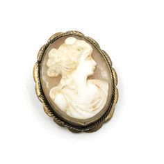 Beautifully detailed carved cameo set in a gold toned frame.  There is also a bail, that appears to be added later, so you can hang it from a chain. The frame is unmarked/unsigned.  In good vintage condition overall. Measures: 1.1" Tall x .9" Wide Weight: 5.48 grams Please feel free to contact me with questions and/or for additional photos. More cameos in the shop: Cameo link bracelet - www.etsy.com/BaseFare/listing/1333721914 Cameo tie tack - www.etsy.com/BaseFare/listing/1182095266 *Free Shipping on Domestic Orders Over $35* All orders ship USPS Ground Advantage. If you would like to add insurance please reach out before purchase. All of our items are in good, vintage condition; because of their past lives expect some minor surface abrasions and small chips or hairline cracks through som Antique Cameo Brooches Collectible, Victorian Style White Cameo Brooches, Antique Cameo Medallion Brooches, Gold Cameo Medallion Brooches, Antique Cameo Brooch Collectible, Gold Cameo Medallion Brooch, Antique Cameo Medallion Brooch, Ornate Cameo Brooches For Collectors, Vintage White Cameo Brooch