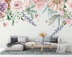 a living room with flowers painted on the wall