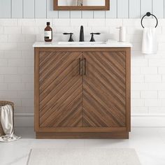 a bathroom with a sink, mirror and towel rack