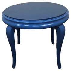 a small blue table with legs and a round top on the bottom, against a white background