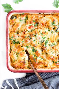 a casserole dish with cheese and vegetables