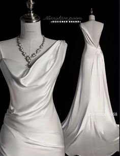 a white dress on display in front of a mannequin headdress and necklace