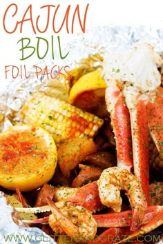 a close up of a plate of food with crab legs and corn on the cob