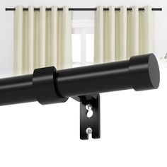 a black curtain rod with two white curtains hanging from it's side, in front of a window