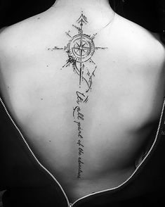 a woman with a compass tattoo on her back