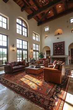 a large living room with lots of windows and couches on top of a rug