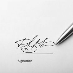 a pen sitting on top of a piece of paper next to a signature signature