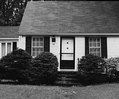 a black and white photo of a small house