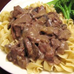 pasta with beef and broccoli on a white plate, ready to be eaten