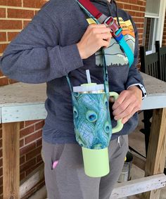 a woman is holding a cup in her hand