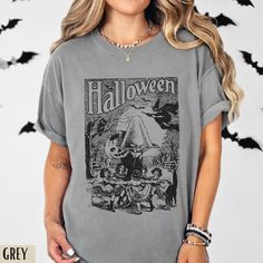 Vintage Comfort Colors Halloween Shirt | Halloween Poster Shirt | Jack O Lantern Shirt | Witchy aes | Halloween Tshirt | Retro Halloween Comfort Colours Tee:  * 100% ring-spun cotton * Medium fabric (6.1 oz/yd² (206.8 g/m * Relaxed fit * Sewn-in twill label * Machine Washable  * Unisex Fit - Refer to sizing guide in photos for sizes  Care Instructions *PLEASE READ*  * Cold machine wash only on a gentle cycle with similar colours - wash garment inside out  * Use standard washing powder only; it i Cotton Graphic Print Top For Costume Party, Gray Cotton Top For Halloween, Halloween Graphic Tee Shirt, Halloween Graphic Print Tee Shirt, Halloween Graphic Print Shirt, Horror Graphic Print Top For Costume Party, Grunge Halloween Tops With Character Print, Grunge Graphic Print Tops For Halloween, Halloween Grunge Tops With Character Print