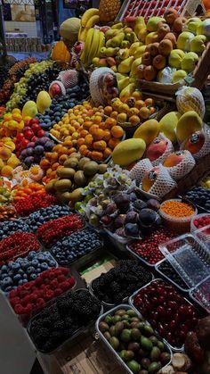 an assortment of fruits and vegetables on display at a market