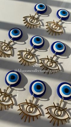 blue and white evil eye earrings are on display