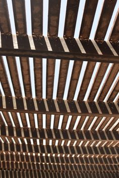 the underside of a wooden structure with metal bars