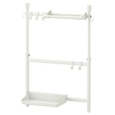 a white shelf with two hooks on the top and one hanging from it's side