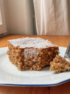 a piece of cake sitting on top of a white plate with a fork in it