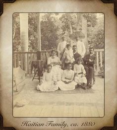 an old photo of some people sitting on a porch with trees in the back ground