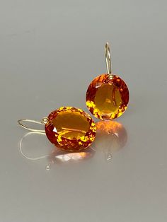 Gorgeous Madeira Citrine drops earrings. The oval  Madeira Citrine drops are eye clean, flawless, and have a beautiful rich golden whiskey color. The drops are attached to 24k gold vermeil /14K SOLID GOLD ear wires. The earrings are elegant, have a lux look, and make a statement.  A truly gorgeous pair of earrings. When 14K SOLID GOLD ear wires are being used, the ear wire ends are hand-stamped as proof of being 14K solid gold. In addition, extra work was done at the end of the ear wires to prev Orange Teardrop Gemstone Earrings, Formal Round Topaz Earrings, Orange Gemstone Drop Jewelry, Luxury Citrine Earrings, Orange Drop Gemstone Jewelry, Formal Orange Gemstone Earrings, Fine Jewelry Briolette Faceted Earrings, Orange Citrine Gemstone Earrings, Citrine Gemstone Drop Earrings