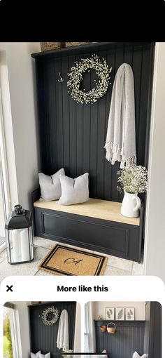 a black bench with pillows and wreaths on the wall next to it is an entryway