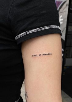 a person with a tattoo on their arm that says, made of memories in cursive writing