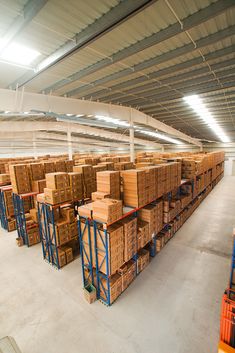 the warehouse is filled with boxes and pallets