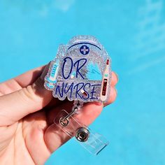 someone is holding up a badge with the word or nurse on it in front of a swimming pool