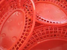 red plastic plates stacked on top of each other