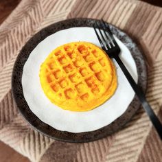 a waffle on a plate with a fork