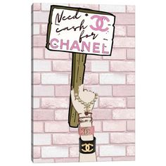 a pink brick wall with a chanel sign hanging from it's side,