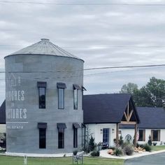 an old grain silo sits in the middle of a rural town