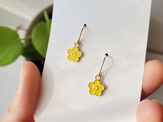 "How cute are these sunshine yellow daisy flower earrings? The yellow enamel and gold charm brightens up any outfit. These small hypoallergenic earrings work for every aesthetic. Simple, Cottage, Boho - anyone? :)  Handmade in the rainy NW, from these materials: 14k gold fill ear wire   *hypoallergenic + safe for sensitive skin gold plated enamel daisy CARE TIPS: These beauties are are low-maintenance but if the ear wire  loses shine, gently buff with a jewelry specific polishing cloth. Use a dry, cotton cloth on the enamel charm. BEST PRACTICE: Put the jewels on last (after shower, hair, makeup).  Avoiding / Limiting exposure to beauty products or harsh environments will extend the life of these pieces. *If you have questions, feel free to ask! Measurement: approx. .75\" More Enamel Earri Yellow Daisy Flower, Blue Crystal Earrings, Yellow Jewelry, Daisy Earrings, Yellow Earrings, Tourmaline Beads, Bead Charm Bracelet, Colorful Earrings, Dangly Earrings