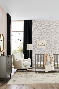 a baby's room with a crib, rocking chair and dresser in it