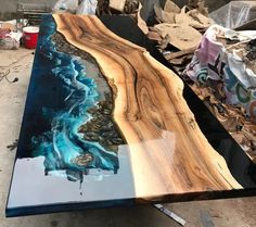 a table that is made out of wood and has blue paint on the top of it