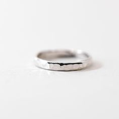 This ring features a thick hammered half-round sterling silver band. It looks great worn on its own, or combined with our other rings to create a stacked look. Made from high-quality .925 sterling silver, it is sure to be a piece that lasts. Each piece is custom-made for you, so please allow 1-5 days for the jewelry to ship. - .925 Sterling Silver - 3mm band - Handmade to order at our studio in Salt Lake City, UT - Comes neatly packaged in a kraft jewelry box ready for gifting Hammered Sterling Silver Midi Rings, Minimalist Hammered Silver Stackable Rings, Minimalist Hammered Sterling Silver Midi Rings, Minimalist Hammered Round Band Ring, Everyday Hammered Sterling Silver Stackable Rings, Minimalist Hammered Midi Rings For Anniversary, Modern Sterling Silver Hammered Rings, Silver Hammered Minimalist Midi Rings, White Gold Hammered Stackable Rings Gift