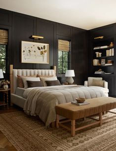 a bedroom with black walls and white bedding