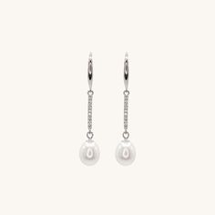 Elevate your style with these stunning sterling silver dangling pearl earrings. These versatile earrings are suitable for any occasion, making them an essential addition to your jewelry collection. For a complete look, pair them with our classic pearl bracelet or necklace collection. Timeless Sterling Silver Pearl Earrings, Elegant White Pearl Charm Earrings, Classic White Drop Linear Earrings, Hypoallergenic Long Drop Pearl Earrings, Classic Pearl Pendant Drop Earrings, Elegant Dangle Pearl Linear Earrings, Minimalist Pearl Linear Earrings For Formal Occasions, White Drop Pearl Earrings For Everyday Elegance, Elegant White Gold Drop Linear Earrings