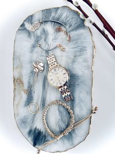 a blue and white plate with jewelry on it