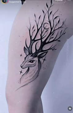 a woman's thigh with a deer tattoo on it