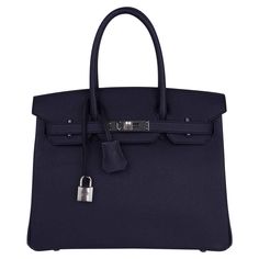 Mightychic offers a rich Hermes Birkin 30 bag featured in Bleu Indigo. This rich deeply saturated dark blue iBirkin bag s a timeless classic. Crisp with palladium hardware. Classic and timeless this beautiful Hermes bag takes you from to evening in one step. Comes with the lock and keys in the clochette, signature Hermes box with ribbon, sleepers and raincoat. NEW or NEVER WORN. final sale BAG MEASURES: LENGTH 30 cm / 12" TALL 21 cm / 8.5" DEEP 15 cm / 6" HANDLES: TALL 4" CONDITION: NEW or NEVER Blue Birkin, Birkin Handbags, Box With Ribbon, Birkin 30, Cargo Pants Outfit, Hermes Birkin 30, Blue Accessories, Hermes Box, Luxury Purses