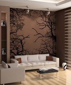 the living room is decorated in brown and white colors with black trees painted on the wall