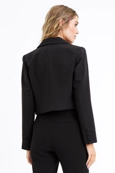 A perfect blend of professional and contemporary style, this elevated blazer features a flattering silhouette, a notched lapel and sleek open front design. If you do not have a cropped black blazer already in your wardrobe... there is NO DOUBT you need to have one! It goes with EVERYTHING! Jeans, skirts, leggings, lounge... we mean it!H 92% Polyester, 8% Spandex Lining: 93% Polyester, 3% Spandex Hand wash in cold water, lay flat to dry Model is wearing a size Small Cropped Black Blazer, Luxury Outerwear, Cropped Blazer, Black Blazer, Front Design, Front Open, Exclusive Designs, Lay Flat, Double Breasted