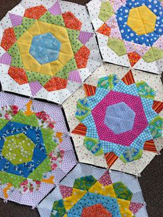 four different types of quilts laid out on the floor