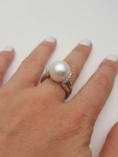 This elegant and timeless pearl and diamonds white gold ring are a must-have in a woman's wardrobe. It goes perfectly with almost anything Great gift for a young lady Beautiful high quality real South Sea and a real diamonds The pearl is a white rose in color, smooth and shiny very clean with high luster The diamond is pave set and is of H/VS quality Hand made * genuine South sea cultured pearl * 13.7 mm in diameter * round in shape * high luster * grade AAA * 18K gold * 0.30 carats total weight Pearl Ring Designs, Vintage Pearl Rings, Big Pearl Ring, Pearl Ring Design, South Sea Pearl Ring, Breastmilk Ring, Pearl Rings Vintage, Cultured Pearl Ring, Real Diamond Rings